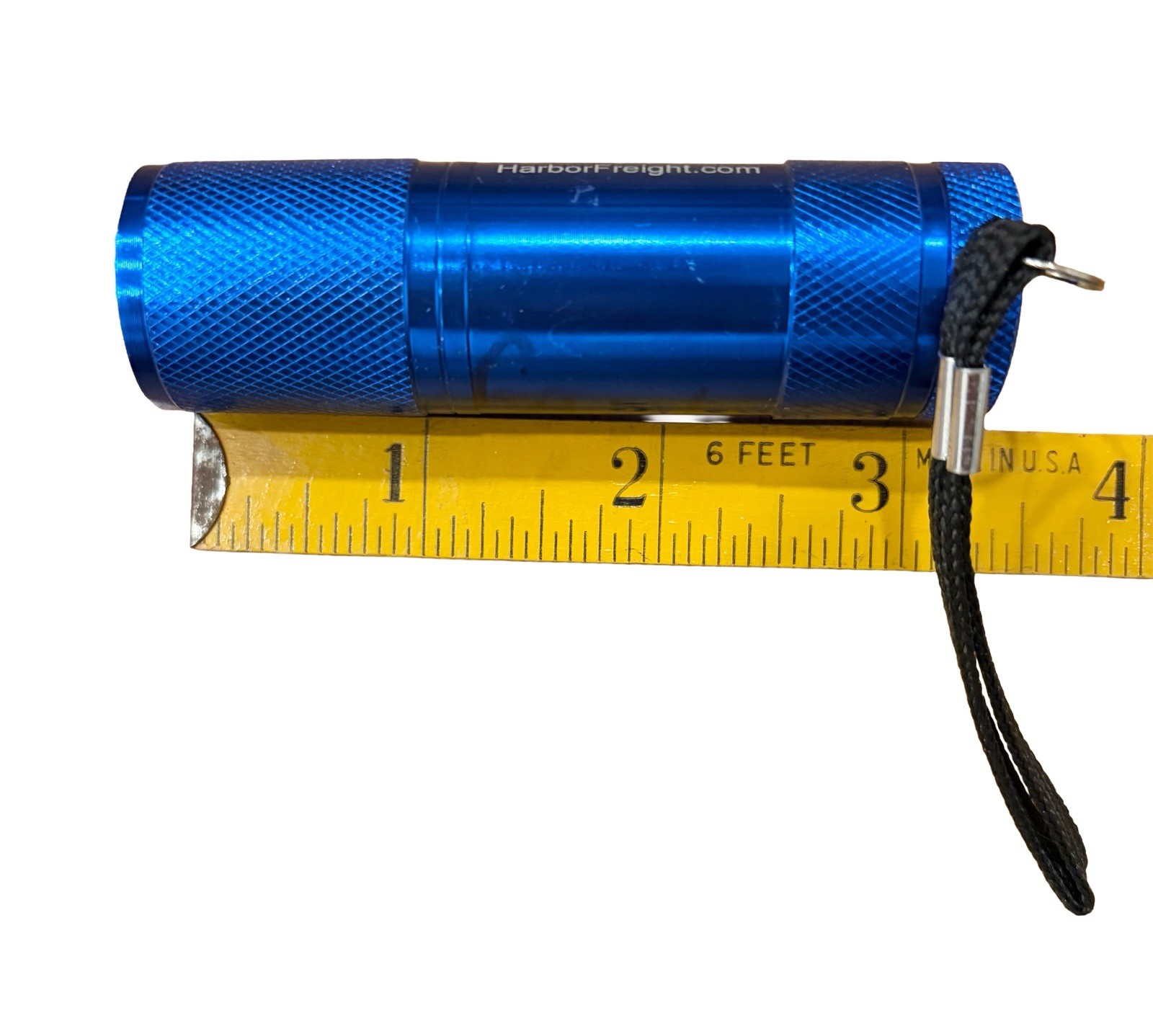 Harbor Freight branded mini aluminum flashlight with a blue finish 3.5”L