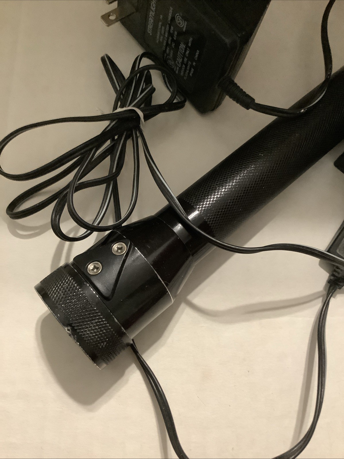 PRE-OWNED FLASHLIGHT, CHARGER 110VOLT, AND CRADLE RECHARGABLE STINGER