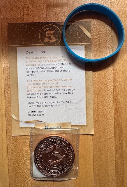 Olight 5th Anniversary Coin with Card and Blue Braclet